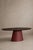 A table with a sculptural presence, where the warmth of solid wood meets the material simplicity of microcement. The oval...