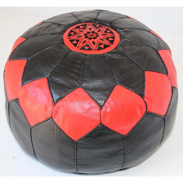 Vintage Moroccan red and black round leather pouf hand tooled in Marrakesh, Morocco. Handcrafted by Moroccan artisans....