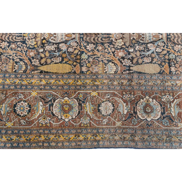 A magnificent example of early 20th-century Persian artistry, this antique Tabriz rug (circa 1900) exudes elegance and...