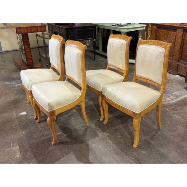 This product is a set of four antique French Charles X Satin Wood inlaid dining chairs. These chairs would be a luxurious...