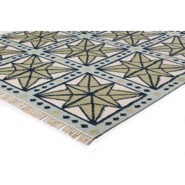 The serene beauty of the Star Rug was inspired by Moroccan tiles and antique American quilts. Symmetrical starbursts...