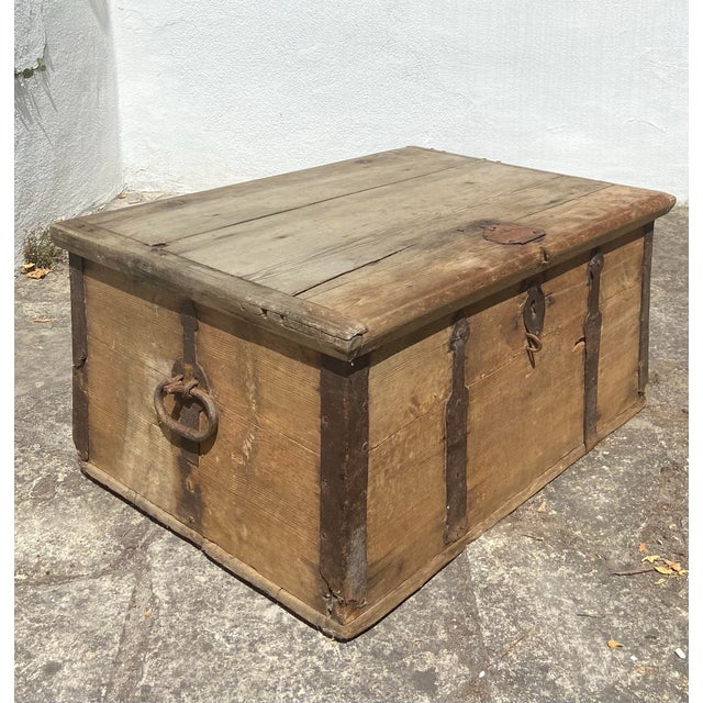 Antique wood chest from Sweden with rustic ironwork, including hinges, handles and corner reinforcements. Interior candle...