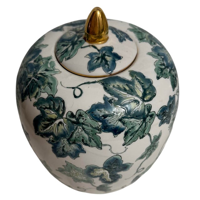 Crafted from porcelain featuring hand-painted botanical or floral designs. The jar includes a white base decorated with...