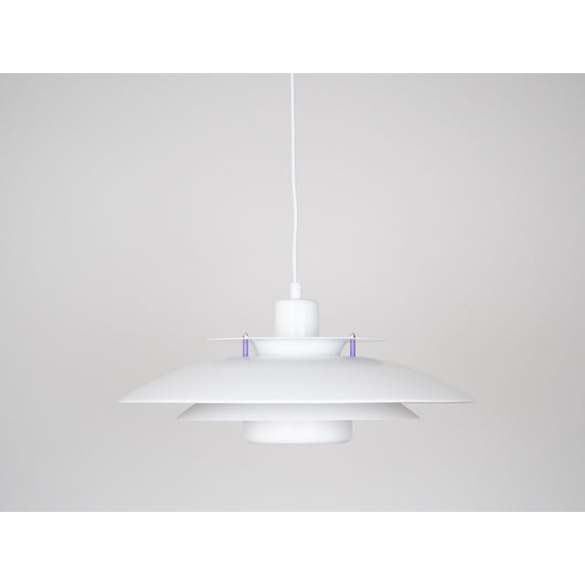 The lamp's form was designed based on the principle of a reflective system that directs light not only downward but also...