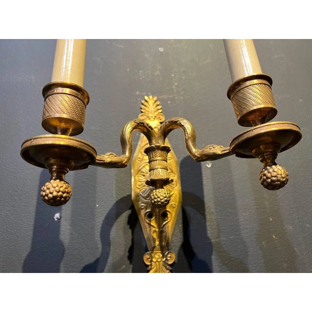 A pair of circa late 19th century French empire double light sconces with swan heads