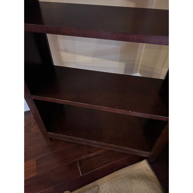 Ethan Allen “Transom” étagère bookcase in a rich dark wood finish, featuring clean, architectural lines and an open-back...