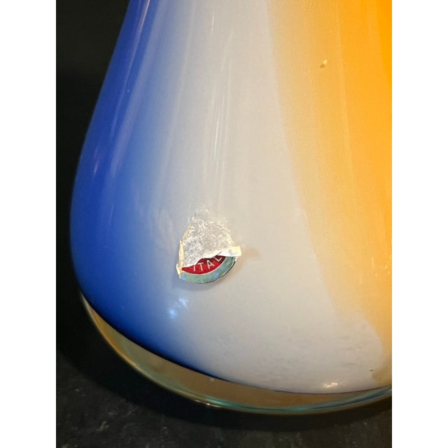 Beautiful Freeform flower shaped vase with pretty shades blue and orange and white. Murano. C. 1970’s Welcome to Solid...