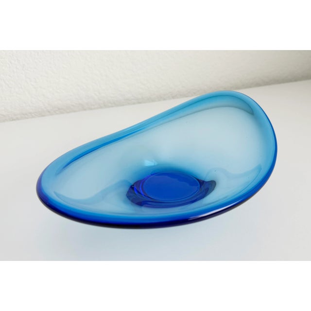 Vintage Danish art glass scoop bowl in vibrant sapphire blue. Designed by Lotta Pettersson for Ikea in the 1990s. This...