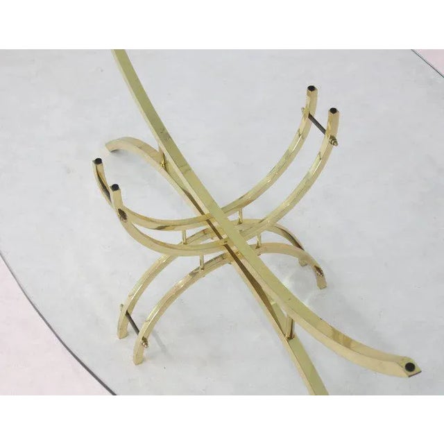 Mid century modern machine crafted brass base with glass top coffee table. Made in the mid 20th century.