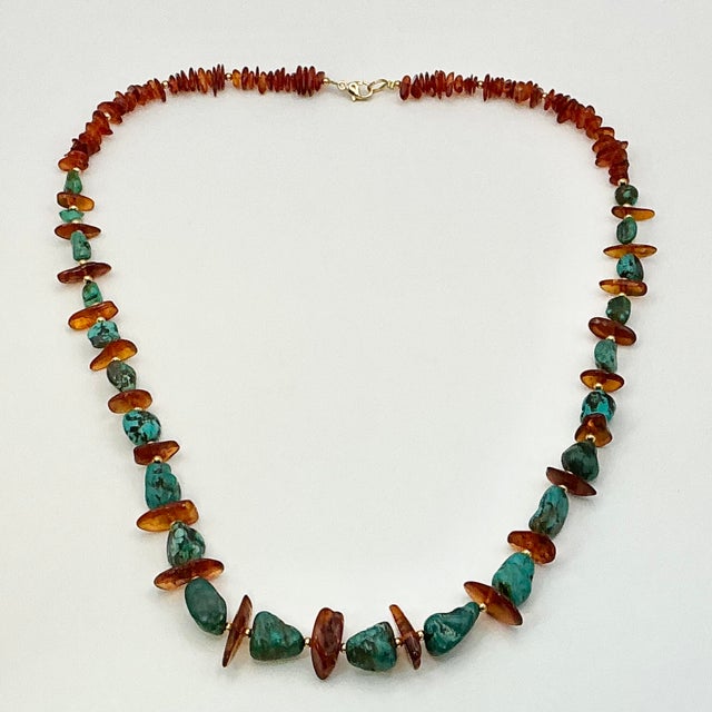 A gorgeous Boho Chic polished natural Baltic Amber nuggets 26” Necklace. The Amber is enhanced with spaced faux Turquoise...