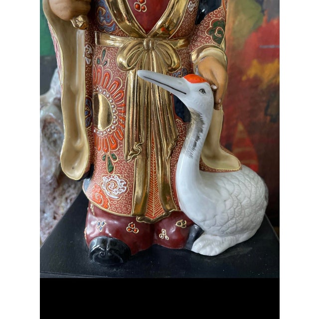 Charming vintage Asian lamp, that depicts an elderly scholar, dressed in traditional robes with his goose at his side. His...