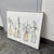 Design Plus Gallery presents a Botanical Floral Bottles Wall Art from Stupell Home Décor. The artwork depicts an...