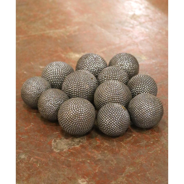 Full of authentic French sporting character, this antique set of traditional boules includes 12 large wooden playing balls...