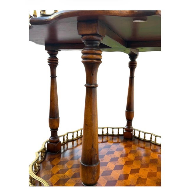 Elegant vintage two-tier occasional table featuring beautifully executed geometric parquetry surfaces framed by decorative...