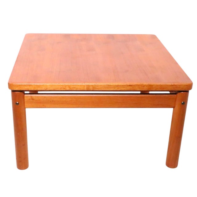 Classic Mid Century Danish Modern by Trioh, circa 1970's. The table features a square floating top, with round dowel form...