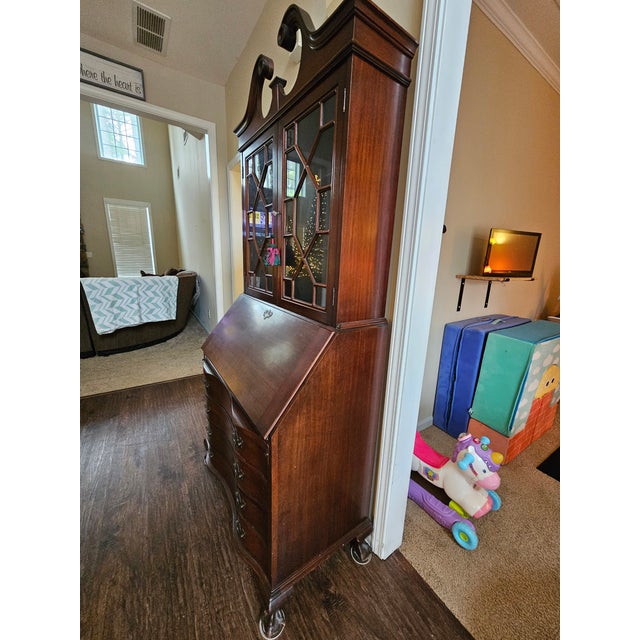 This is a Maddox Chippendale Mahogany Secretary Desk that was made in Jamestown, New York around 1950. It is American...
