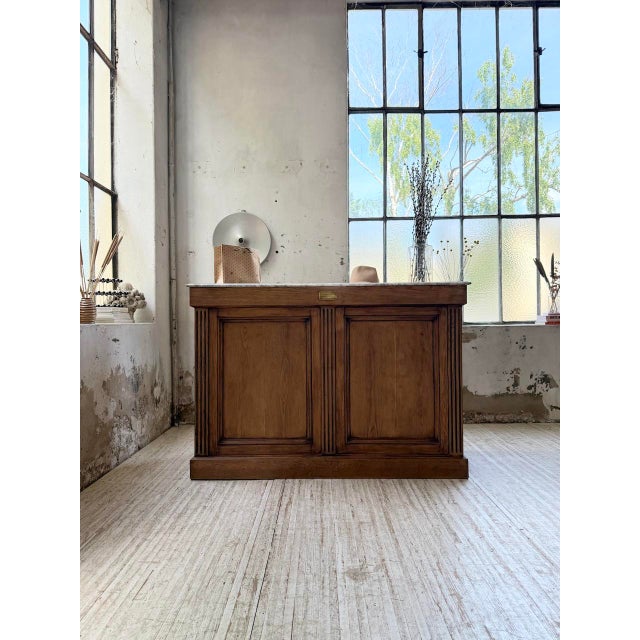 Antique solid oak trading counter with a white marble top. we love its relatively shallow format and its limited length,...