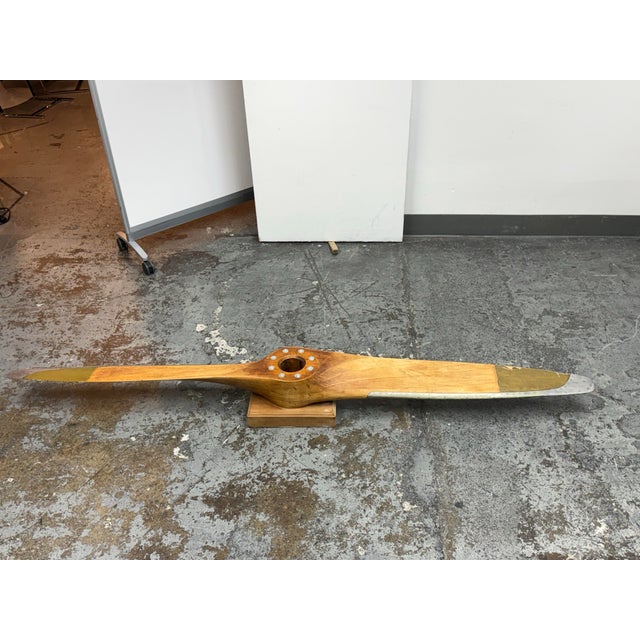 Design Plus Gallery presents a Vintage Wooden Aviation Propeller. This piece has a laminated wood body, metal tip guards,...