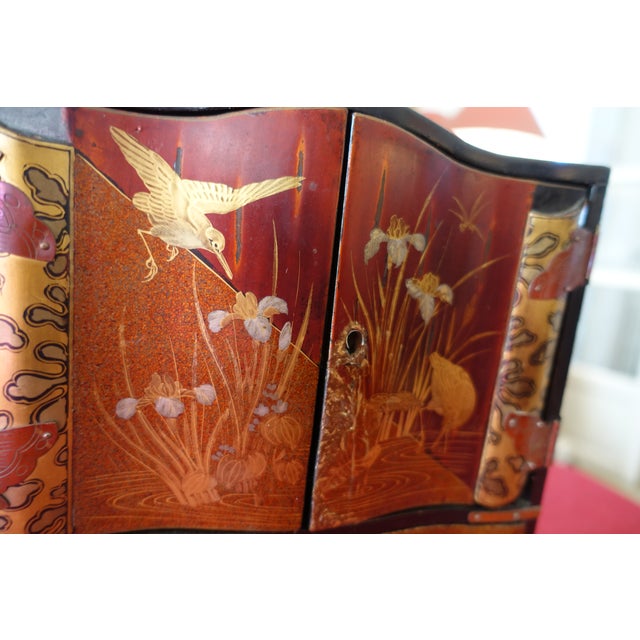 Very beautiful 19th-century Japanese lacquer cabinet, Meiji period. Black lacquer painted with floral motifs for the...