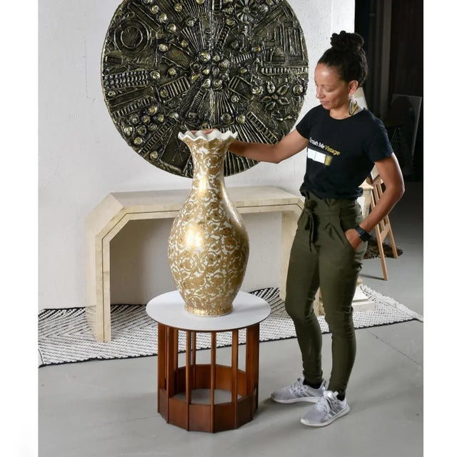 The decadent pear shaped "Yuhuchunping" Chinese porcelain palace vase features a metallic gold botanical pattern. The gold...