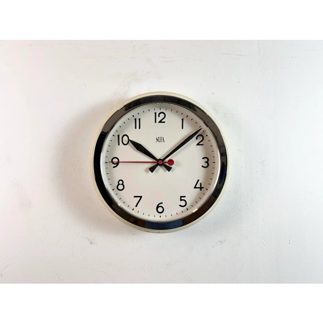 Vintage school or factory wall clock produced by NUFA (Nederlandse Uurwerkenfabriek) in Netherlands during the 1960s. It...