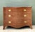 This masterfully crafted George III style commode features a dramatic serpentine front that epitomizes 18th-century...