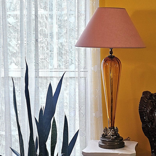 Elegant vintage Murano-style amber art glass table lamp with a sculptural hand-blown glass body, antique brass-tone metal...