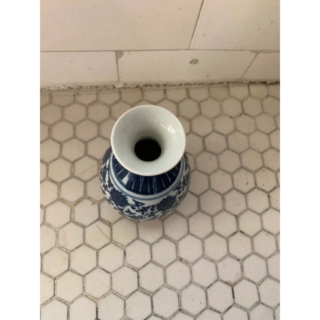 Small Chinese vase with floral blue-and-white chinoiserie transfer pattern. Artist stamp on underside.