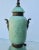 Mottles green glaze on the three-section urn with two bronze bands at the foot and lid were two coiled cobra mounts at the...