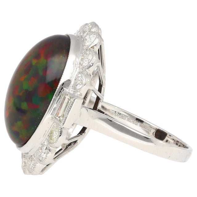 10.08 Carat Black Oval Cabochon Cut Opal with Baguette and Round Cut Diamond on 18k White Gold Ring. Open back setting and...