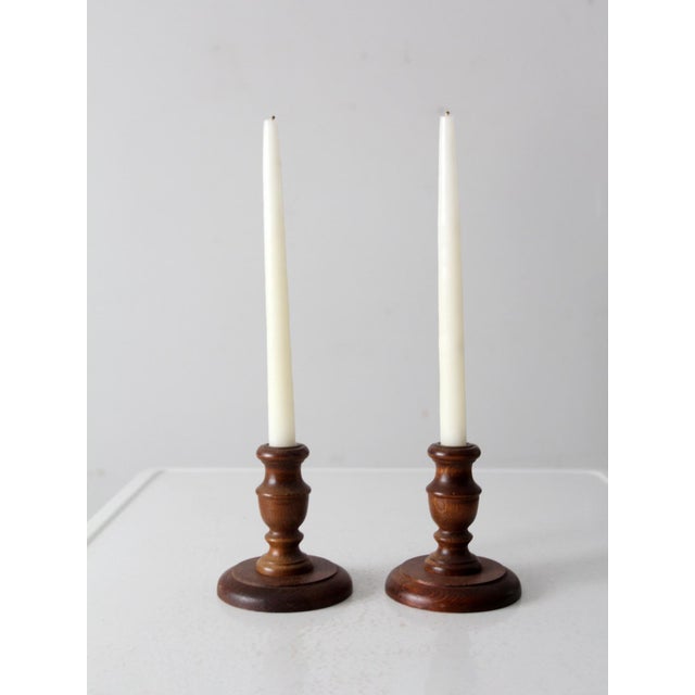 This is a pair of vintage wooden candlesticks. The turned wood candle holders fit a standard taper.