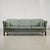 This mid-century three-seater sofa pairs clean lines with thoughtful functionality. Supported by cherry wood legs, the...