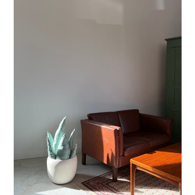 Executed in matte ivory glazed ceramic, a very clean and increasingly rare example attributed to iconic ceramics...