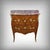 This small marquetry commode, crafted from rosewood and mahogany, exquisitely embodies the spirit of the Louis XV style....