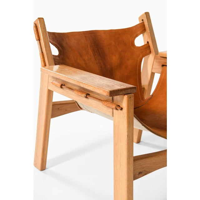 This rare pair of easy chairs, attributed to sergio rodrigues and produced by oca furniture in brazil, stands as an...