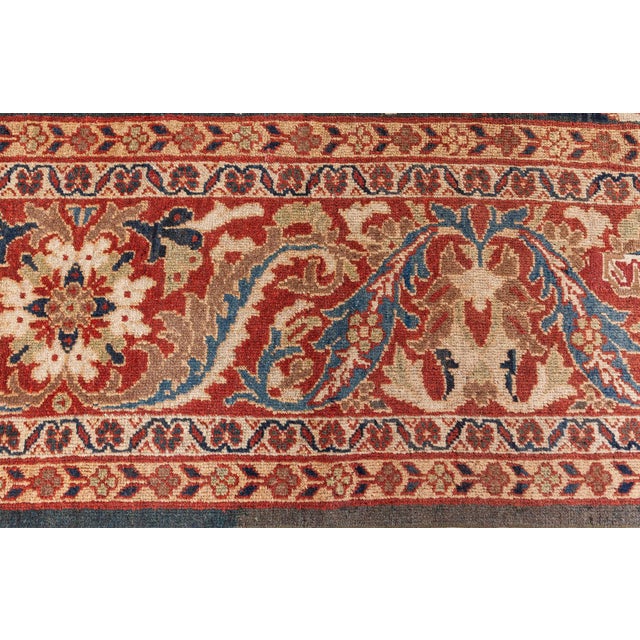 This antique Persian Sultanabad rug, measuring approximately 16 by 12 feet, presents a sumptuous, painterly field of muted...