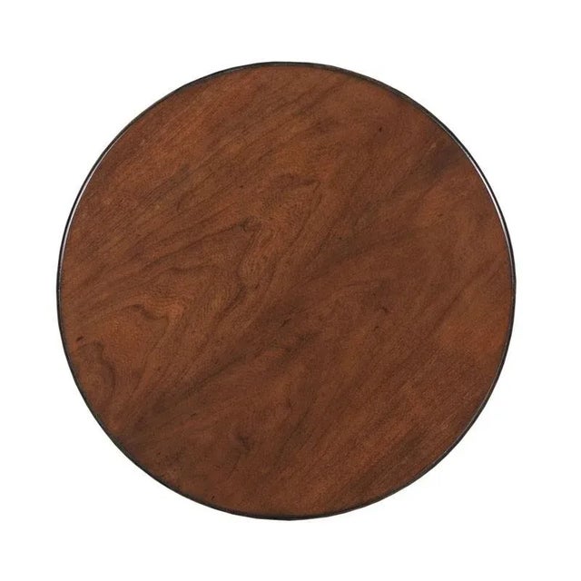 A graceful table with neo-classic roots has a round top resting over four squared tapered posts joined by a middle shelf....