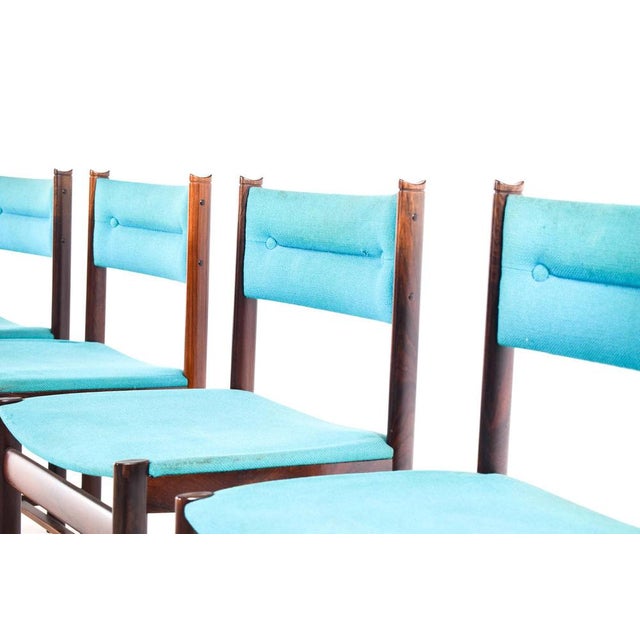 A set of four, beautifully distinctive Danish Dining chairs in solid rosewood, upholstered in a nice blue fabric. This...