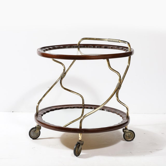 This sophisticated Mid-Century Modernist serving cart offers a combination of elegance and functional design, reflecting...