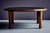 Oval oak coffee table with an inset slate top. A thick rounded oak rim surrounds the dark slate surface, and the table...
