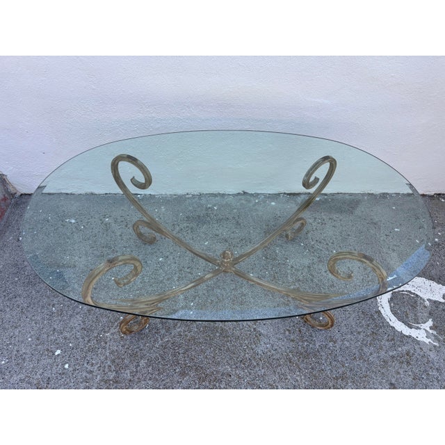 Vintage Hollywood Regency Style Coffee Table Featuring a Gold-Finished Wrought Iron Base With Scrollwork and an Oval Beveled Glass Top For Sale In Los Angeles - Image 6 of 7