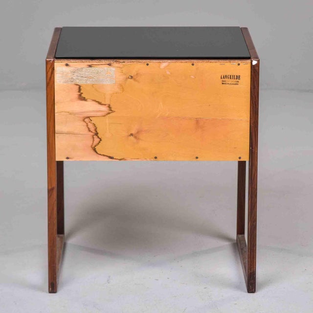 In the tradition of Danish Mid-Century cabinetmaking, this side table by Langkilde features richly figured rosewood...