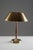 Elegant swedish mid-century table lamp by falkenbergs belysning. The lamp features a gently curved brass shade paired with...
