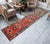 This exceptional vintage runner from 1960s Eastern Anatolia serves as a striking foundation for contemporary interiors,...