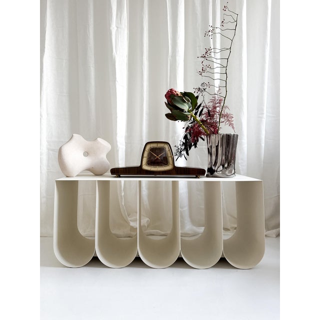 A beautifully sculptural mantel clock that captures the essence of mid-century modern design. Produced in Germany by...