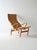 Iconic 'Pernilla' armchair by Bruno Mathsson, with curved wooden structure and woven seat, complete with matching...