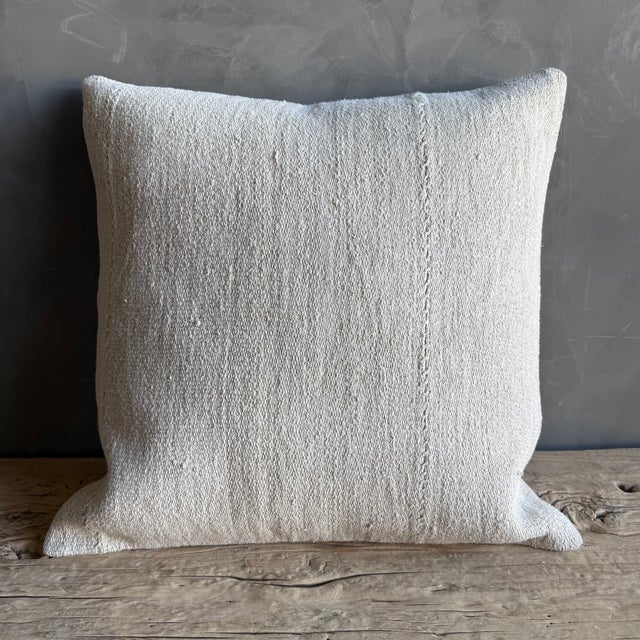 Creamy white hemp rug pillow with original seams. Soft hand, linen blend backing with zipper closure. Spot cleaning is...