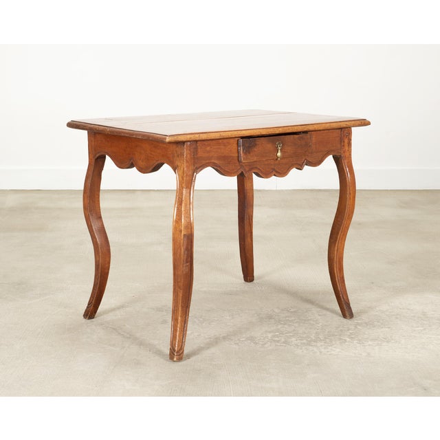A charming 18th century French Louis XV walnut writing desk or side table made in the provincial taste. The distinctive...