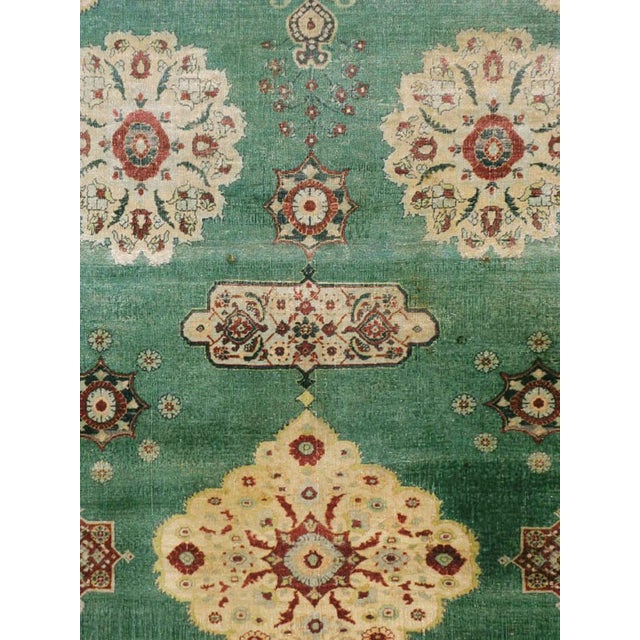 An antique Indian Agra carpet with a weathered appeal from the early 20th century. In the Persian Sultanabad-Mahal style,...