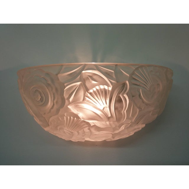 A pair of French Art Deco wall sconces by French Artist “GENET et MICHON” in a clear and frosted molded glass with deep...